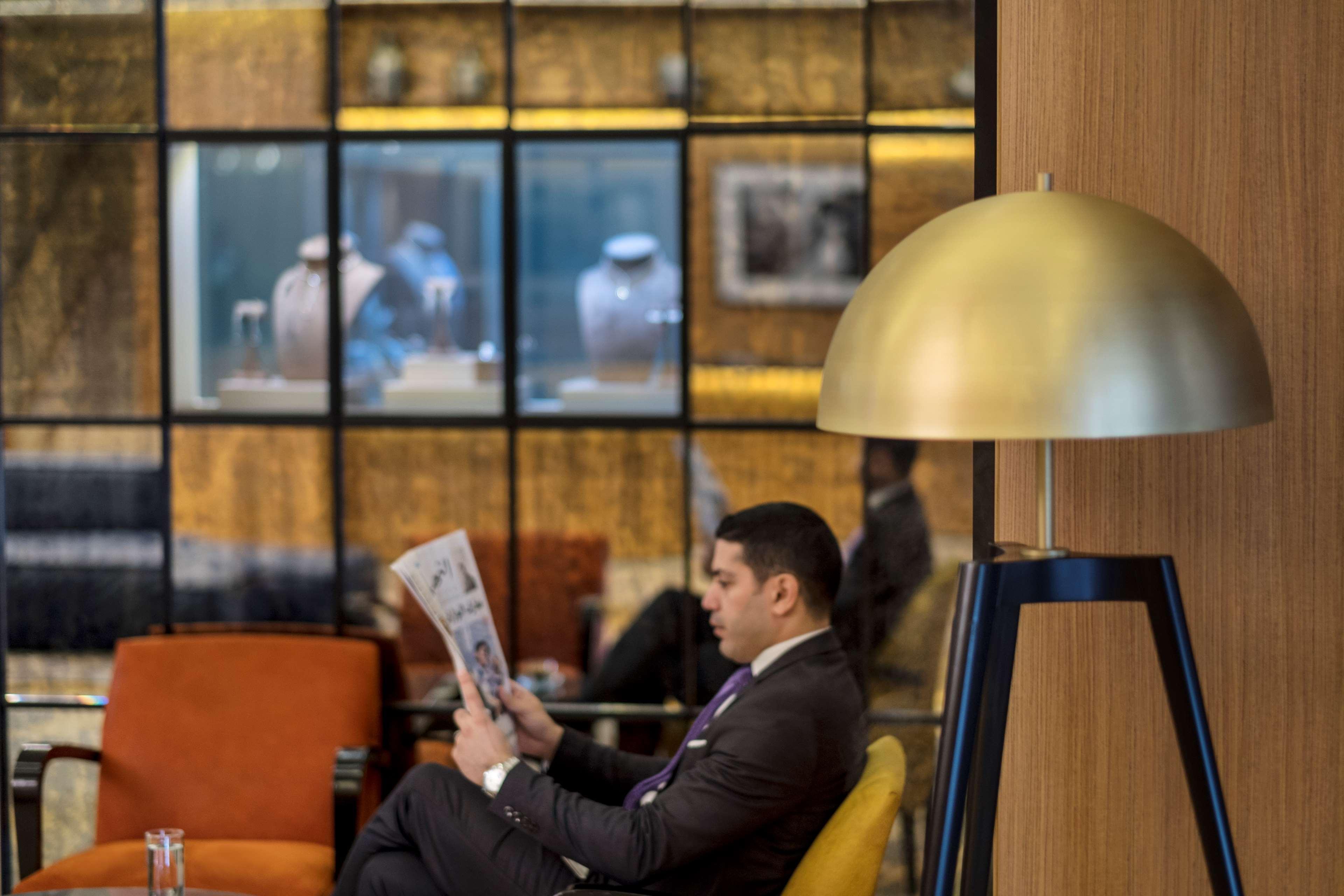 Radisson Blu Hotel, Beirut Verdun Dış mekan fotoğraf A passenger reading a newspaper at the lounge